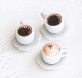 miniature coffee cups, black and cappuccino